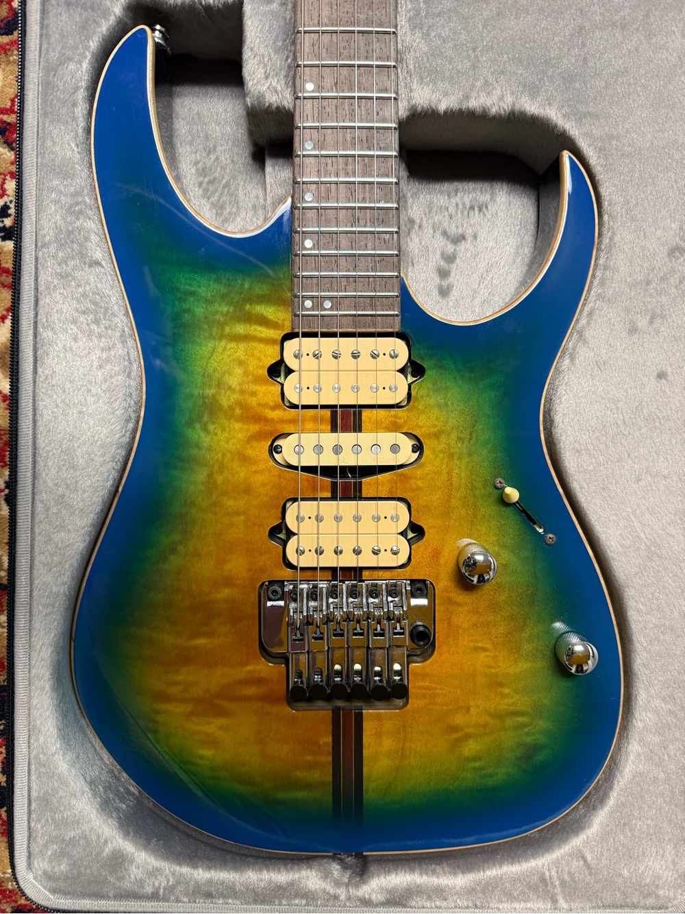 Blue-Green Sunburst Electric Guitar with Triple Pickup Configuration